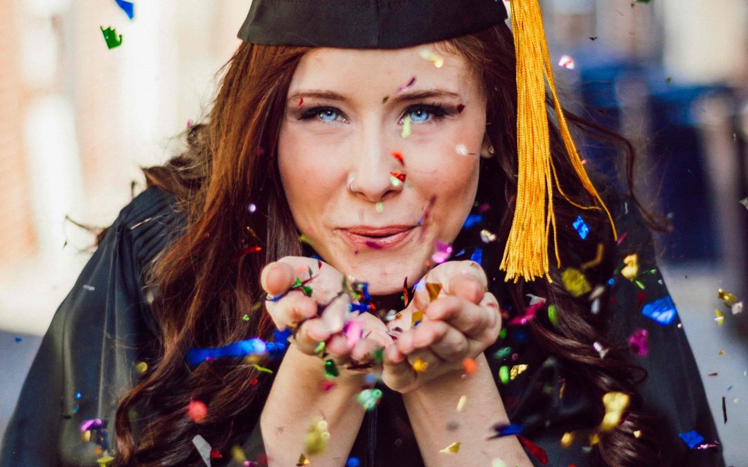 Women in graduate's cap and gown celebrates: Illustrates increase earning potential.