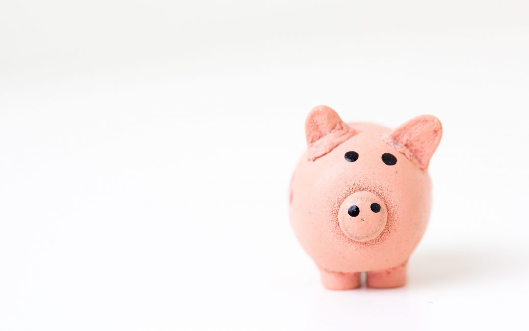 Pink piggy bank to represent savings vs. paying off debt