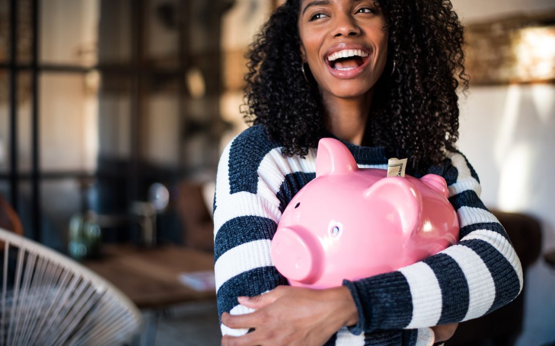 Young woman hugging her pink piggy bank. To represent debt elimination tips