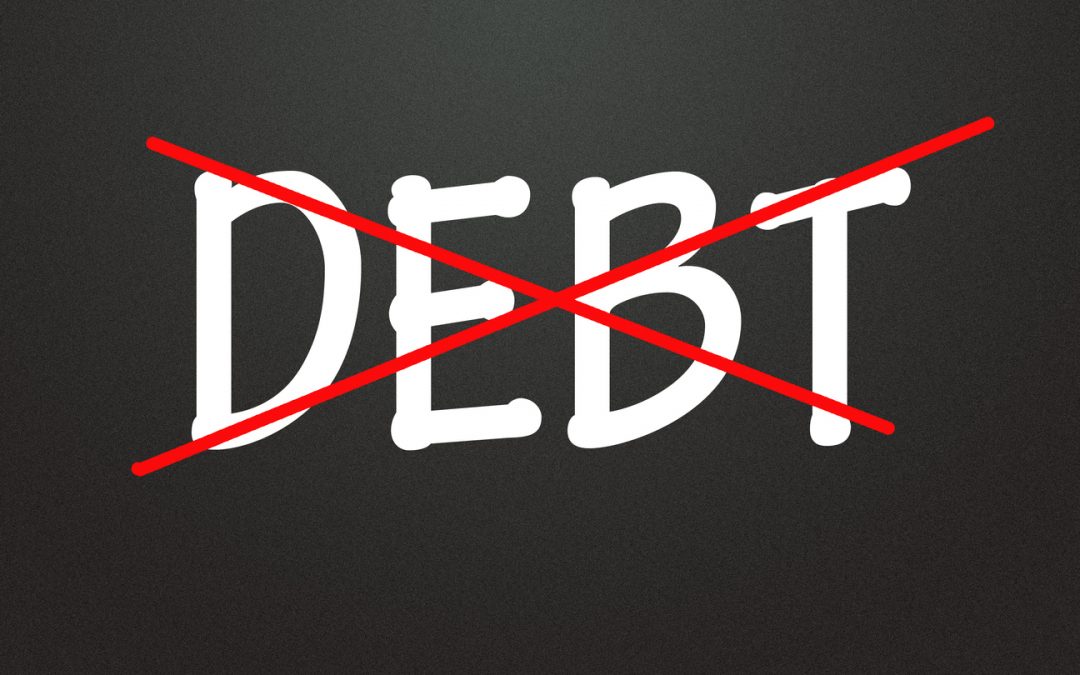 DEBT crossed out in red to symbolize credit card debt payoff