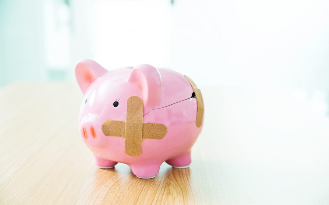 Broken piggy bank with bandages to symbolize how to avoid medical debt
