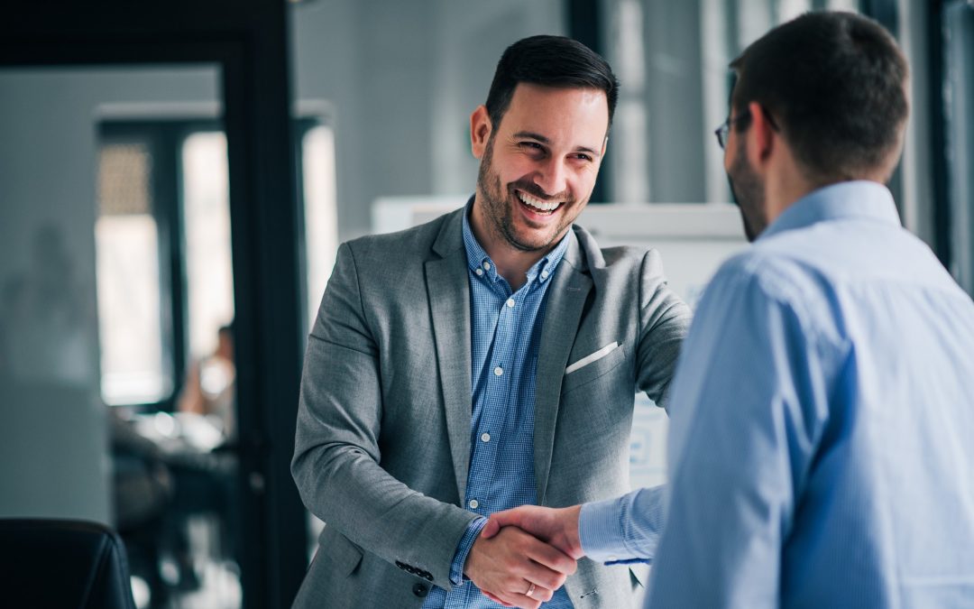 Portrait of cheerful young manager handshake with new employee to illustrate how to ace a job interview