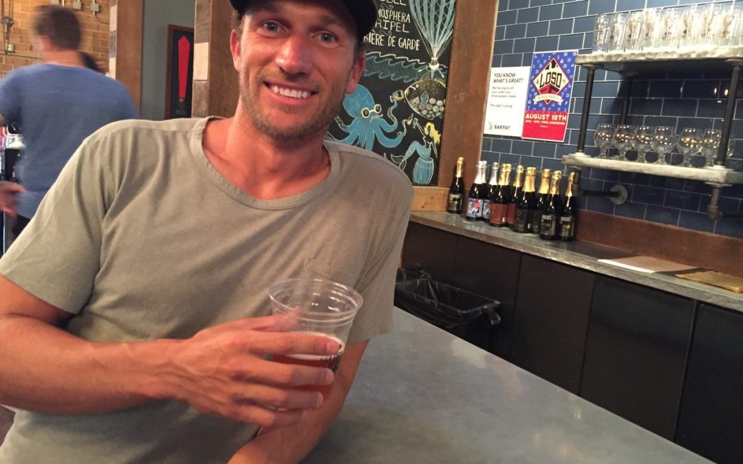 Casually dressed man at bar holding beer: Joe De Pinto shares 5 tips for entrepreneurs.