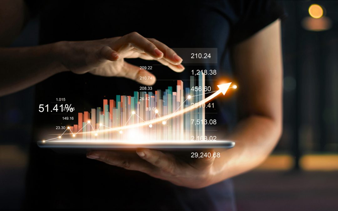 Businessman holding tablet with a virtual hologram of a bar chart with a glowing line curving up. Illustrates income-focused investing